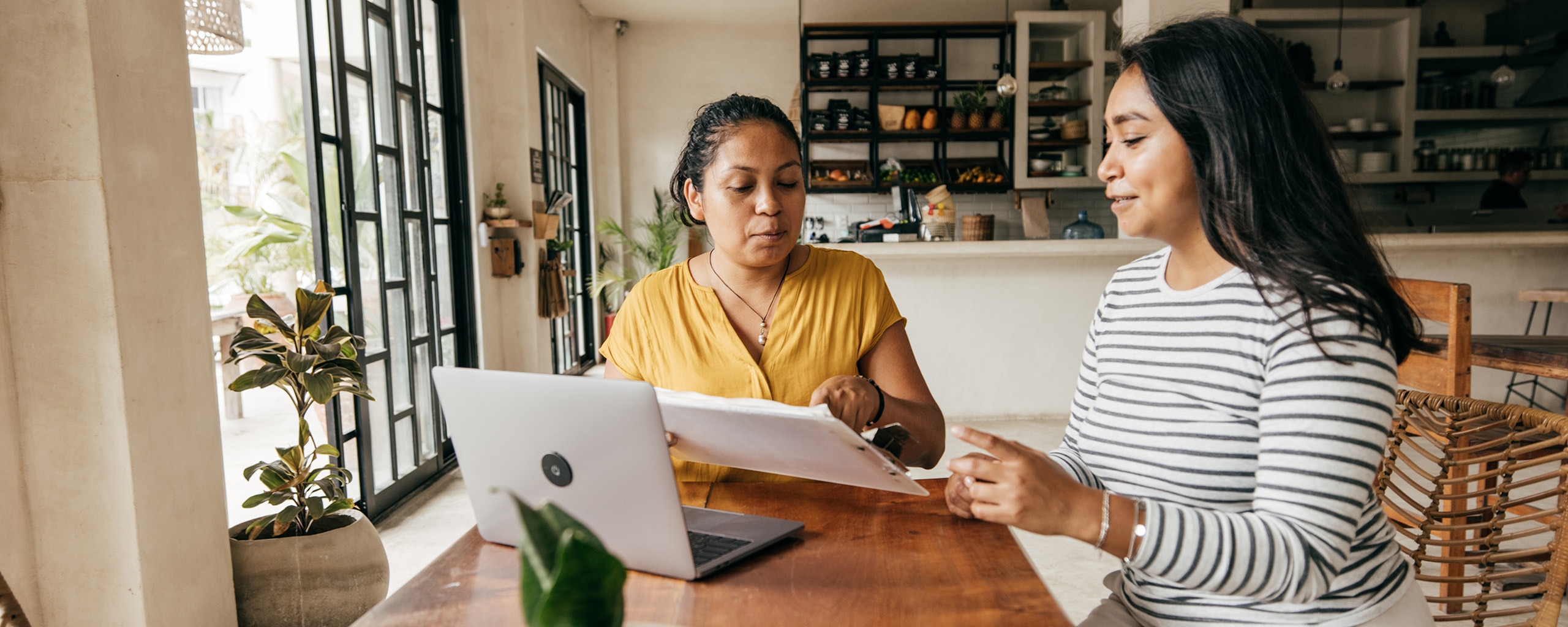 Two people meet in a coffee shop to discuss a job offer and negotiate salary.