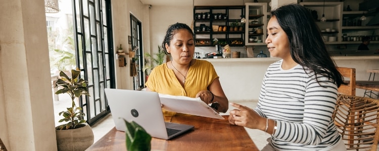 Two people meet in a coffee shop to discuss a job offer and negotiate salary.