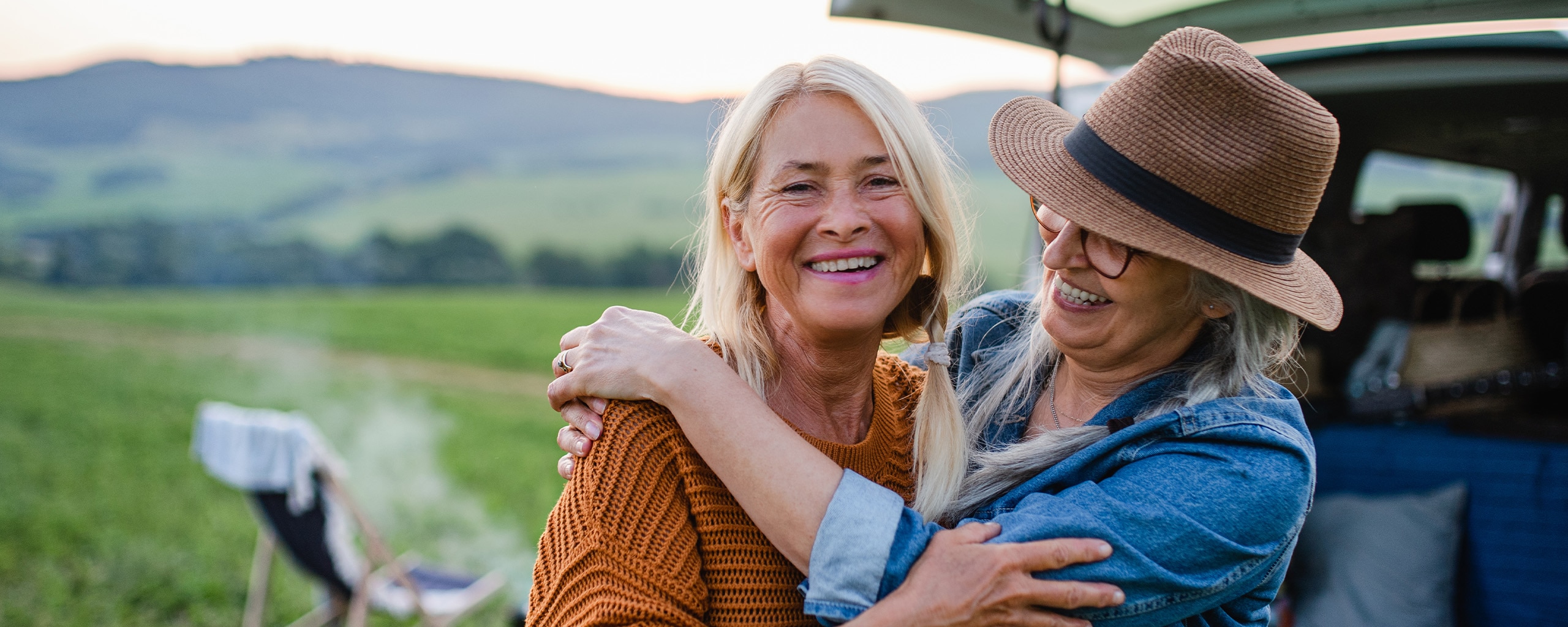 Two smiling people enjoy the outdoors in retirement.