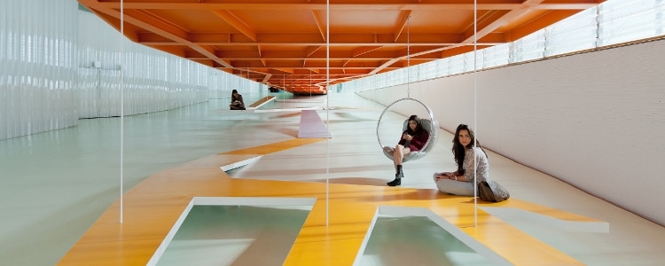 Several museum visitors spend time in an exhibit.