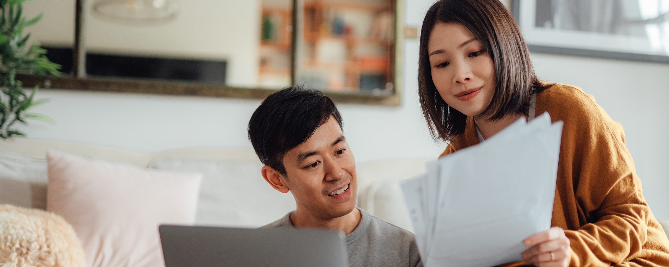 Two people look over debt repayment methods.