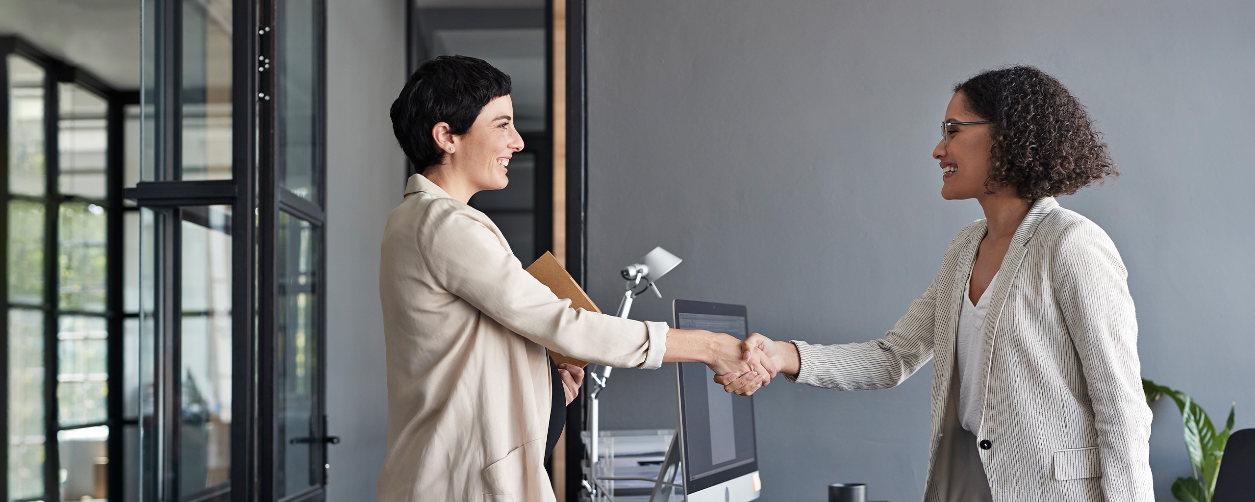Two people shake hands after an interview.
