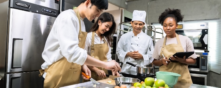 Culinary students exploring alternatives to college—working in a kitchen, learning from an instructor.