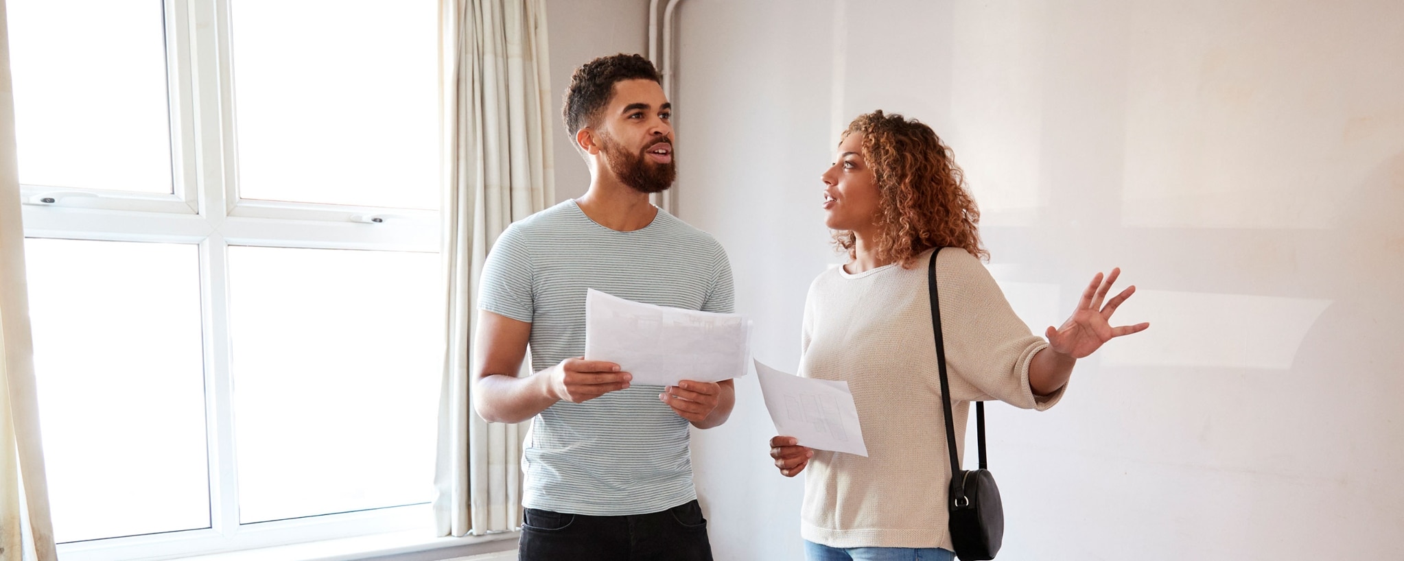 Two people looking at a house they’re considering buying.
