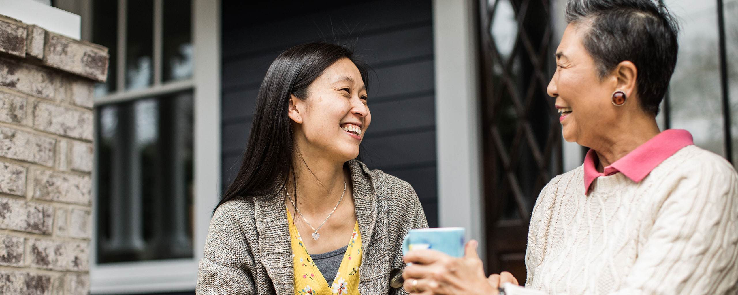 A woman sits on the porch with her adult daughter and discusses her plans for the future.