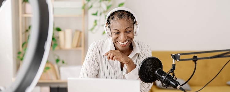 A person records a podcast from their home office.