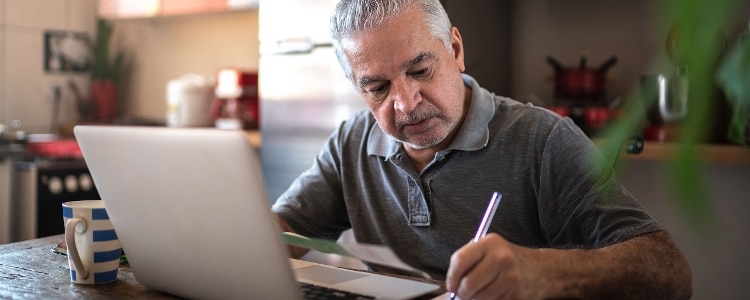 A person uses their laptop to research protections and options for furloughed employees.