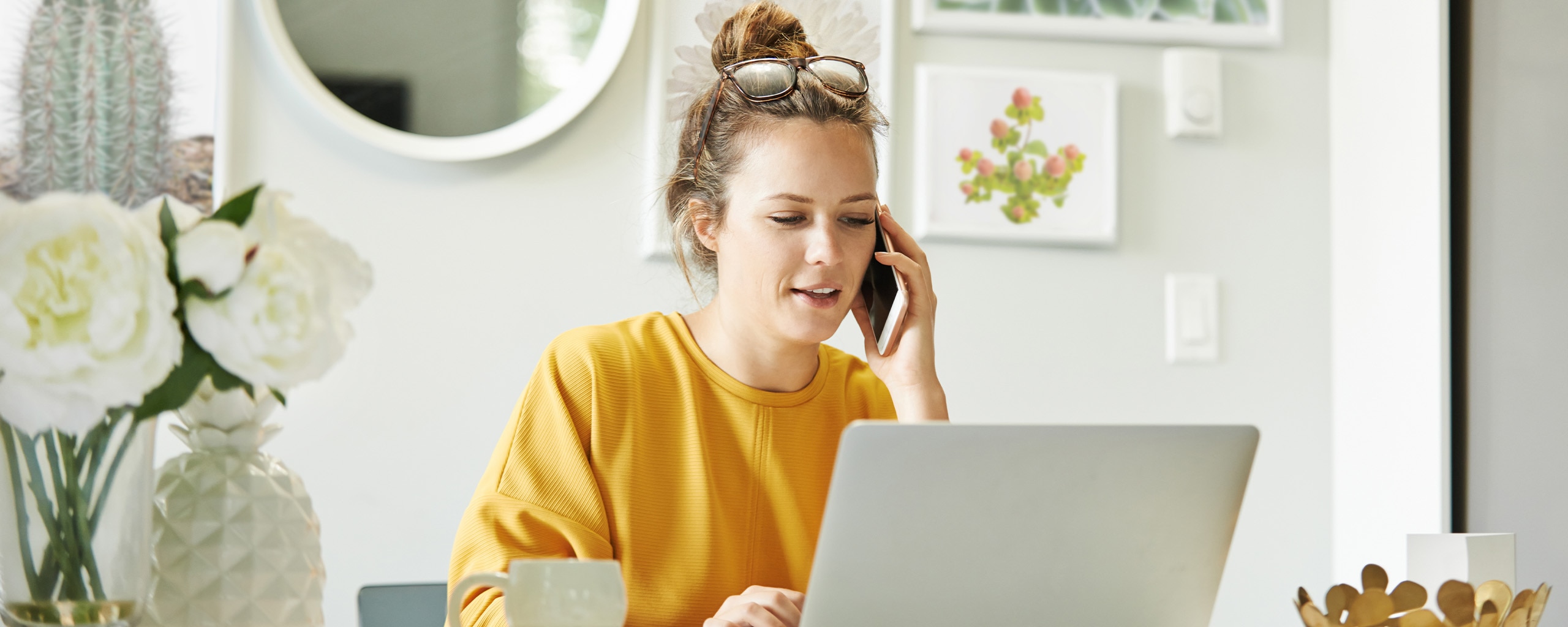 A person sits in front of a computer and looks at health insurance options.