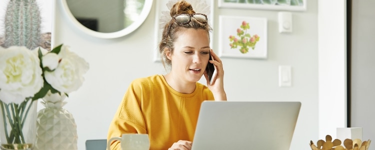 A person sits in front of a computer and looks at health insurance options.