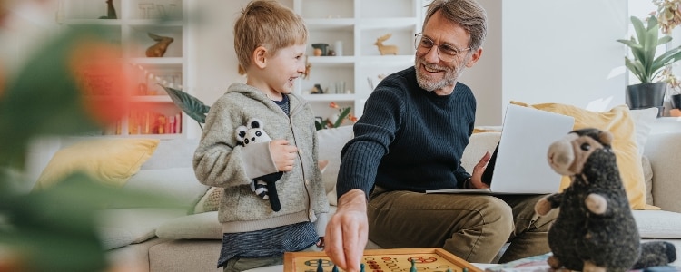 A person plays a game with their grandchild.