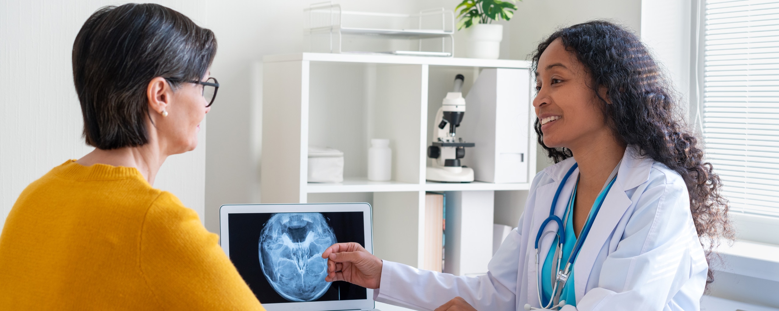 Medical provider goes over an imaging result with a patient.