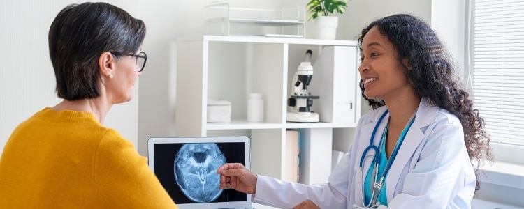 Medical provider goes over an imaging result with a patient.