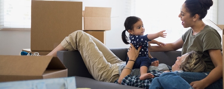 A family takes a break from packing boxes for their cross-country move.