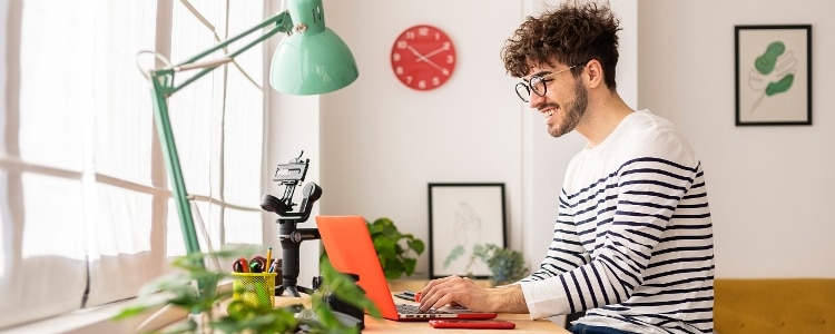 A person looks at their laptop to see they received a bonus.
