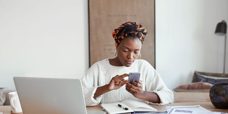 A person learns about hard and soft credit inquiries by using their cellphone.