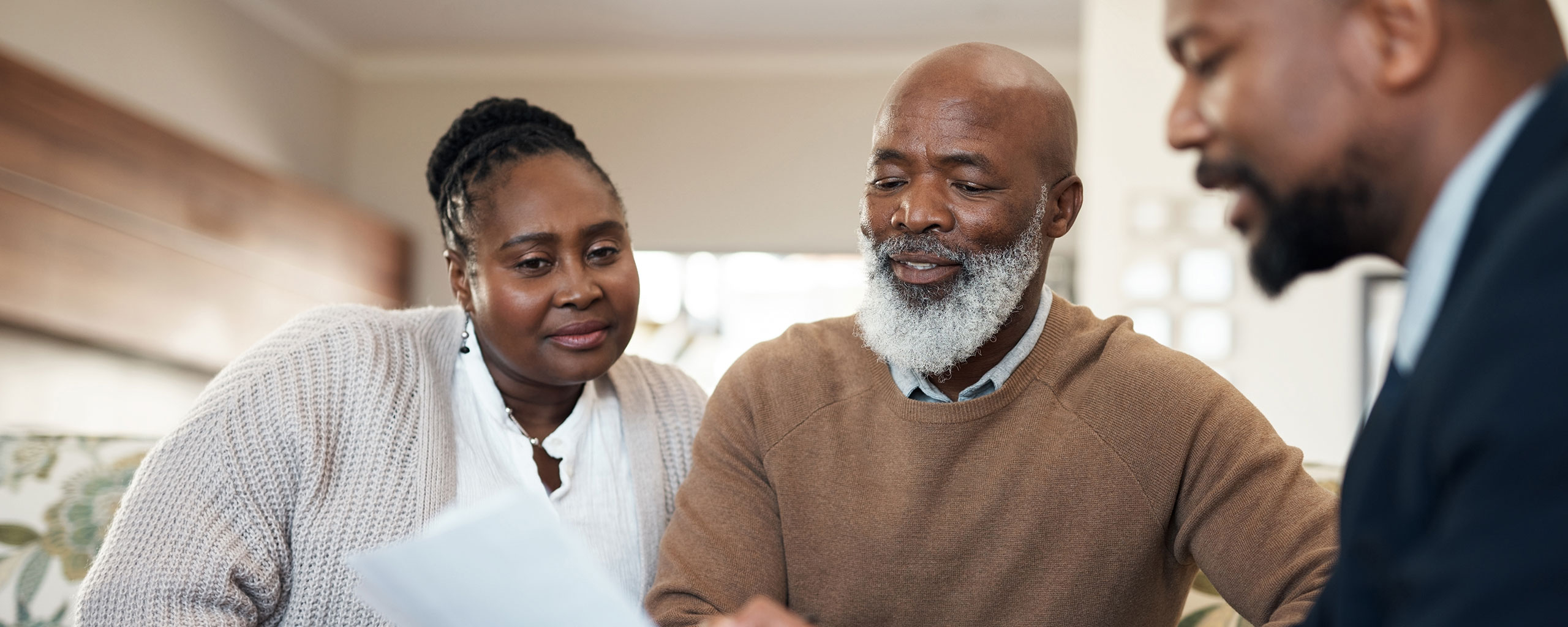 A family looking over a document together.