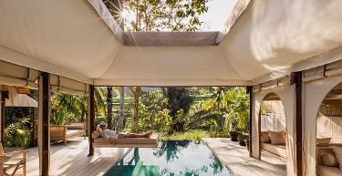 A person napping by the pool while on vacation.