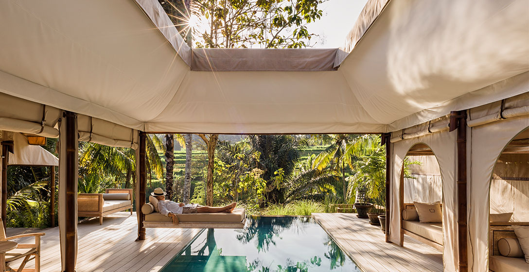 A person napping by the pool while on vacation.