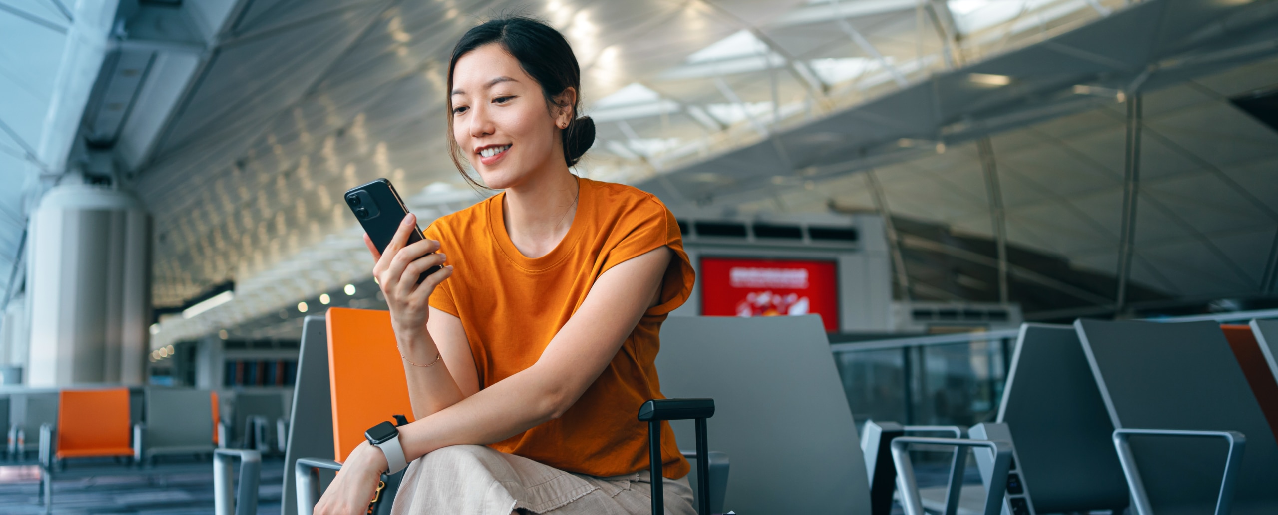 Person using their phone at airport.