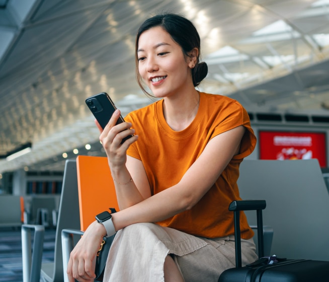 Person using their phone at airport.