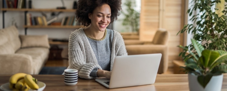 Person using laptop and surfing the net at home.