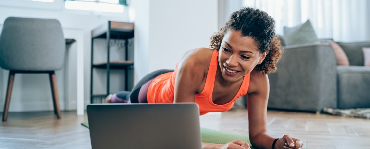Person using laptop to stream workout.