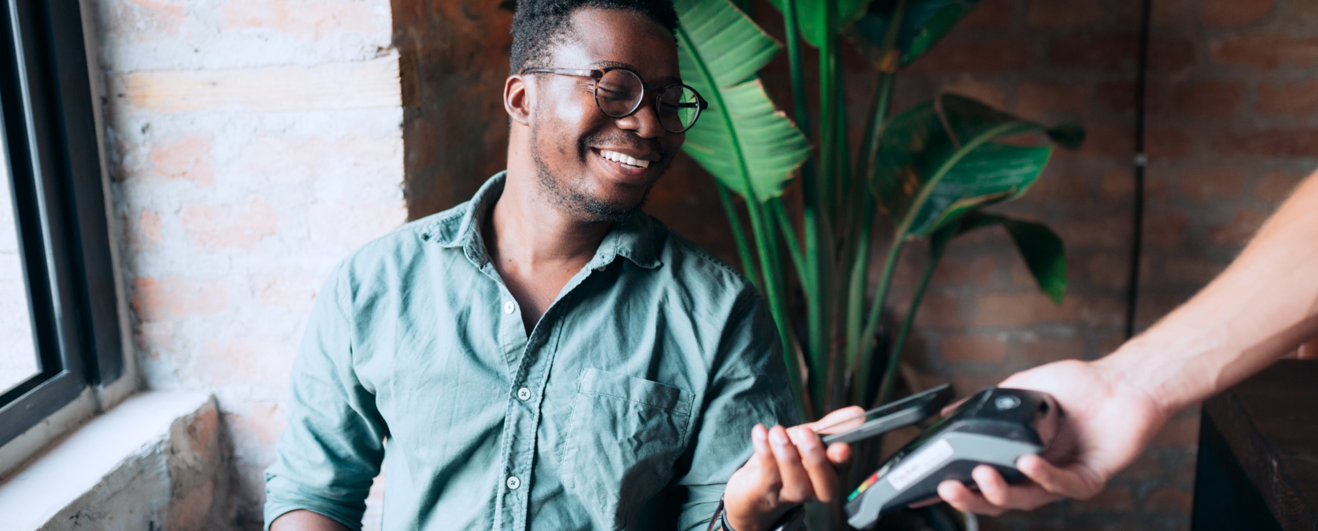 Person holding phone checking out using a mobile payment.