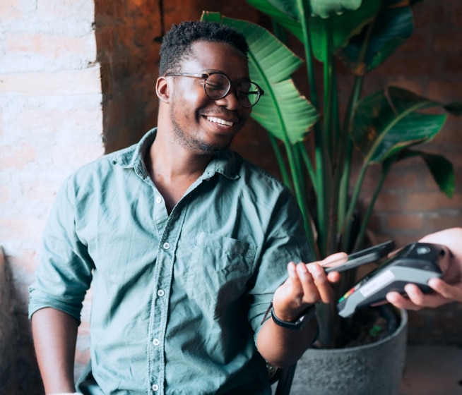 Person holding phone checking out using a mobile payment.