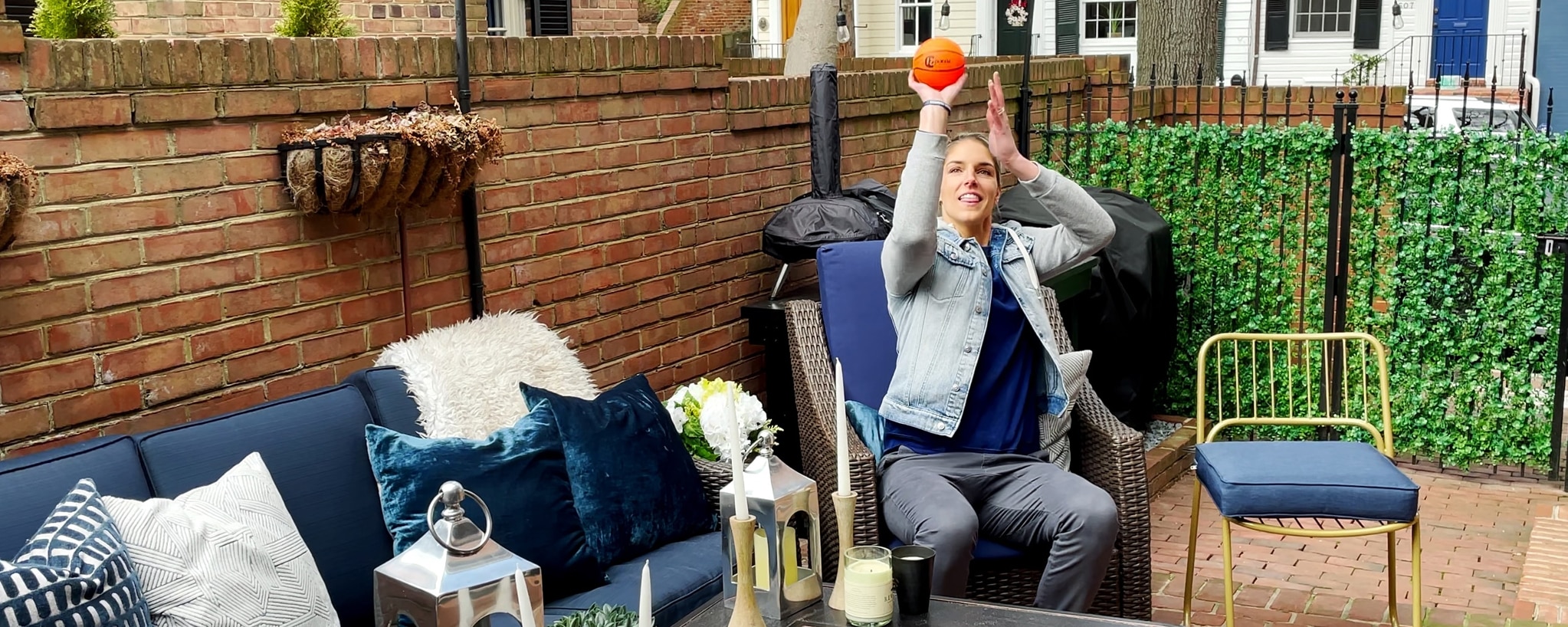 Elena Delle Donne shoots a basketball from the chair in the corner of her patio.