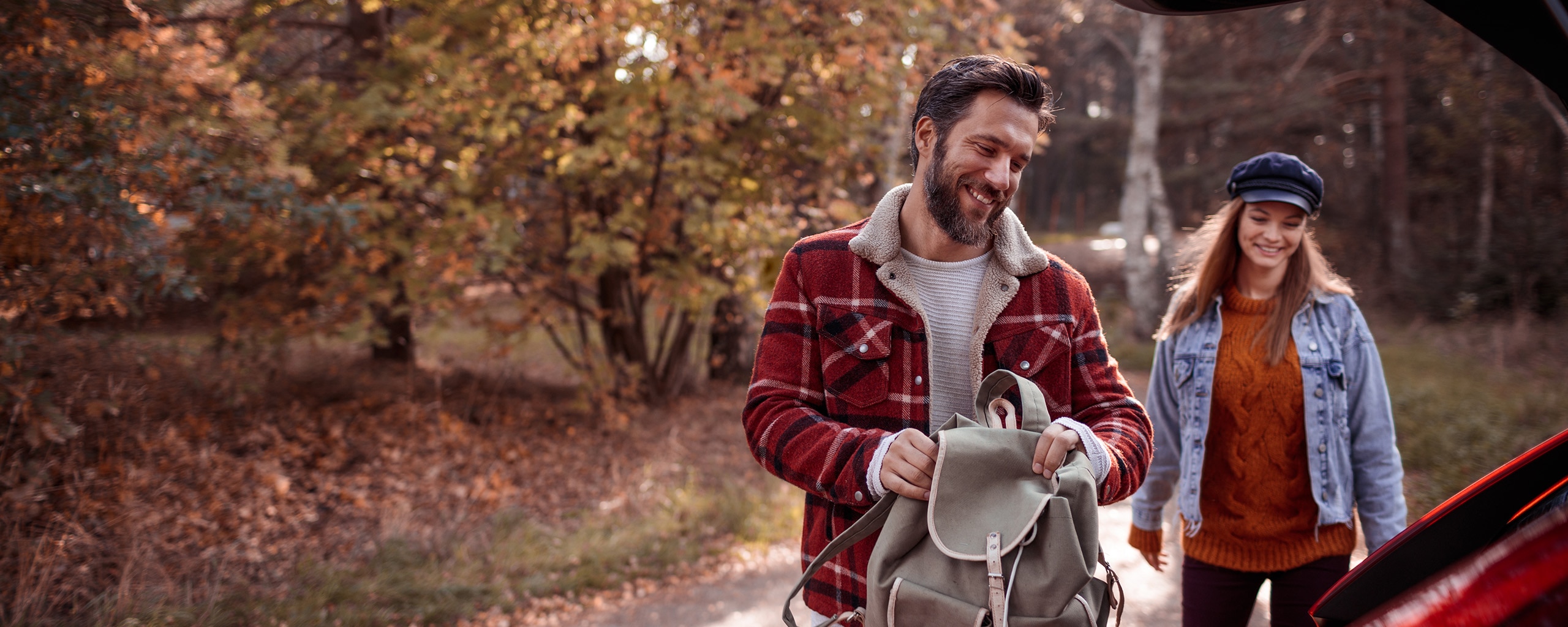 Travelers pack for a road trip.