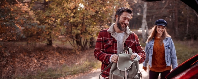 Travelers pack for a road trip.
