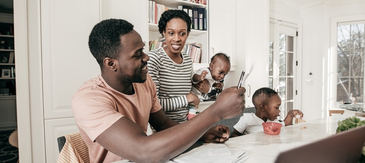 Happy family discussing their finances around the breakfast table