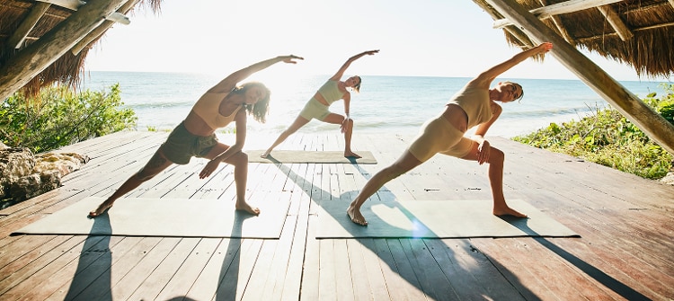 Sunrise yoga in a tiki hut on the beach