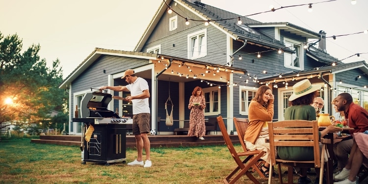 Family grilling in backyard together.