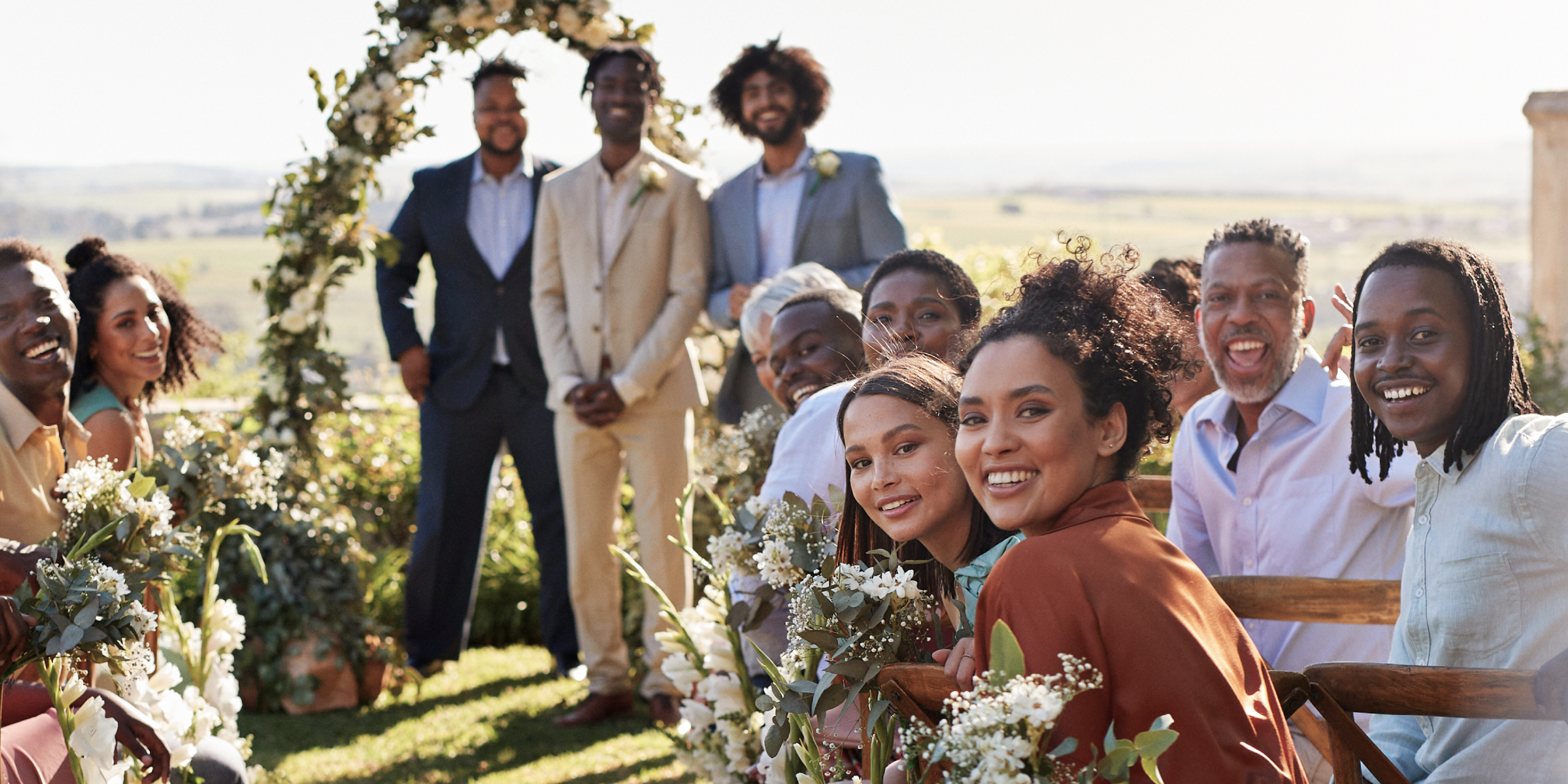 Wedding guests turn away from the altar expecting the bride.