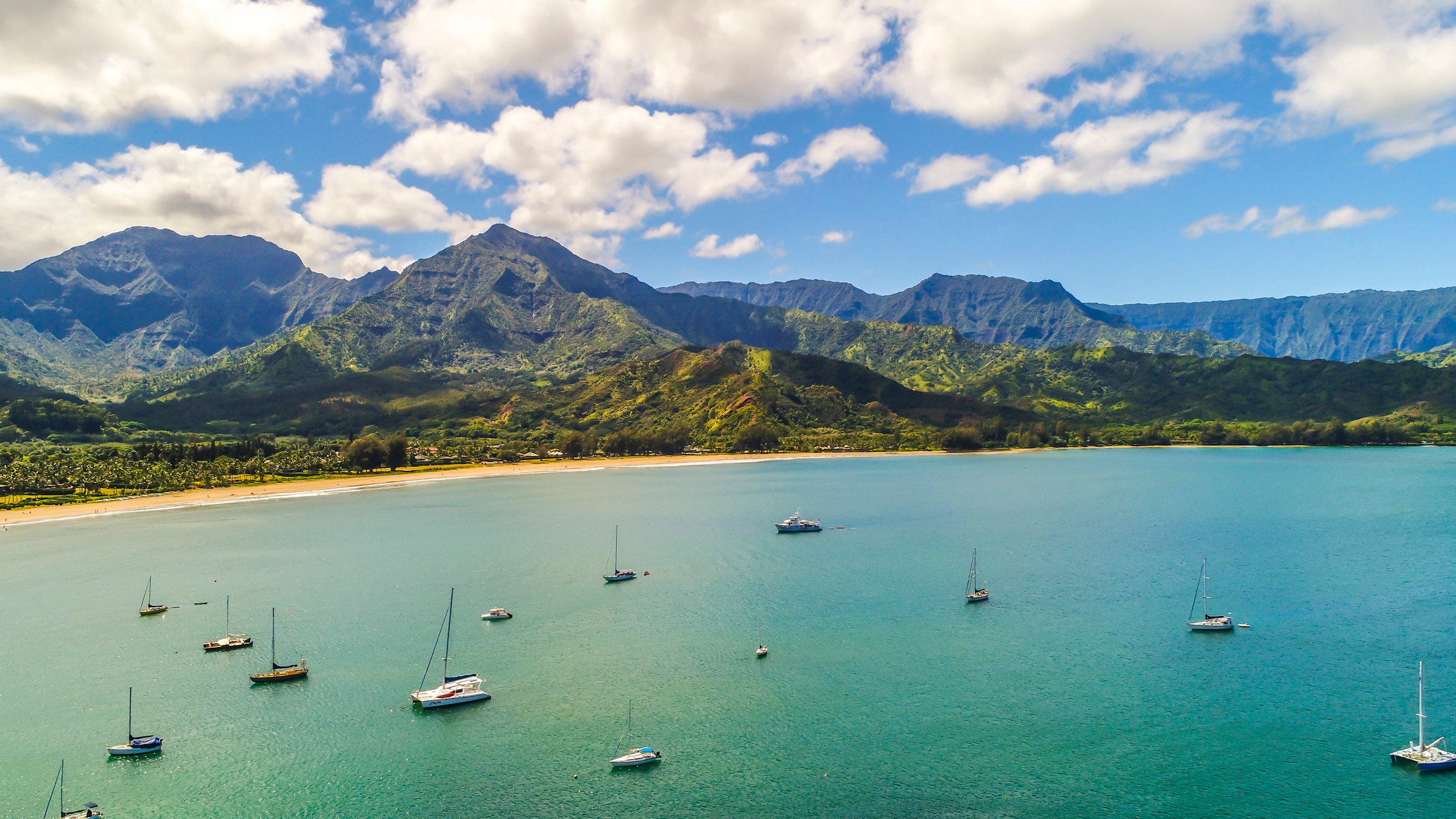 An elevated view of boats on the water at Hanalei Bay in Kauai, Hawaii.