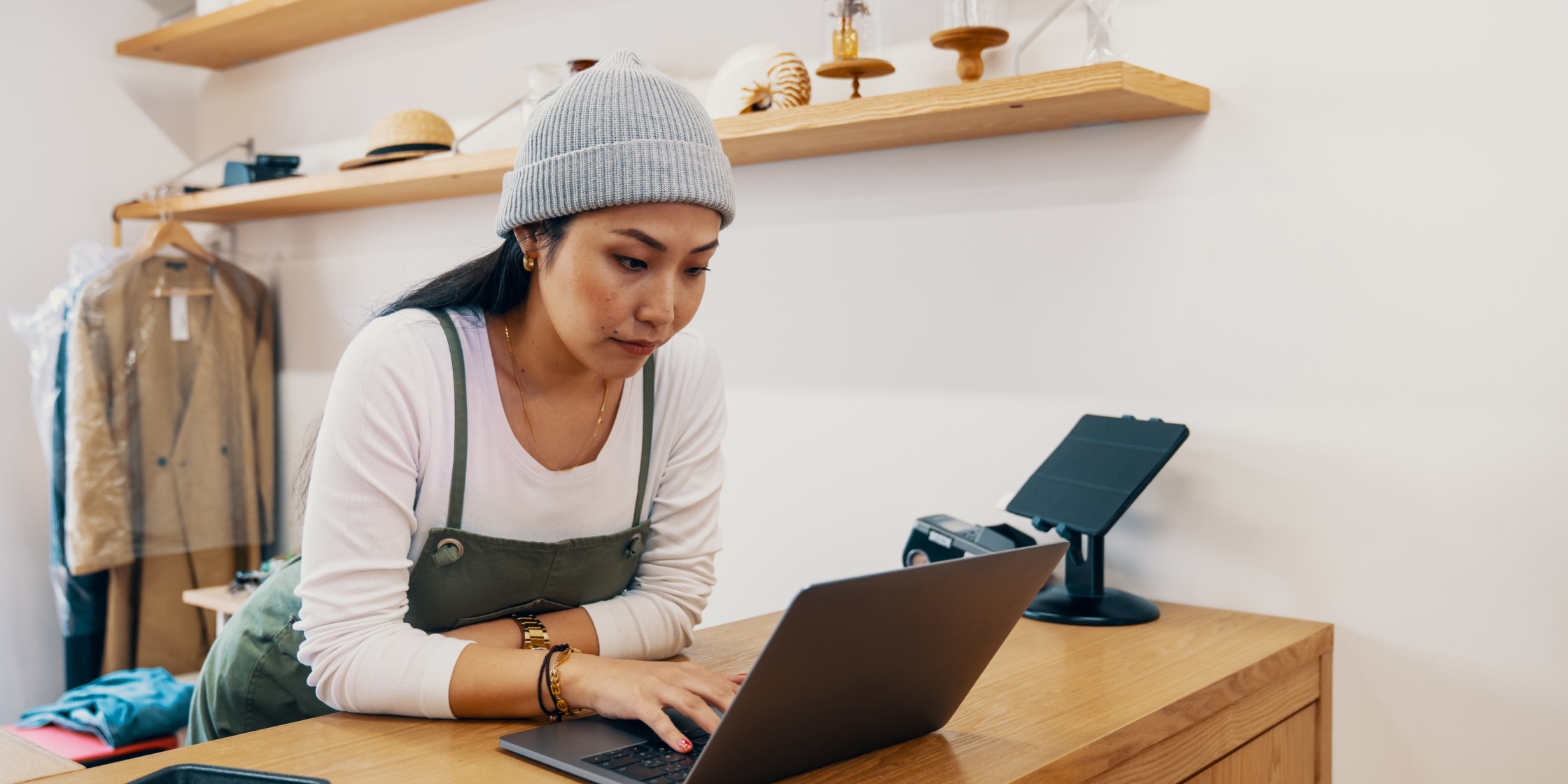 A small business owner working on a laptop to track business expenses and manage cash flow efficiently.