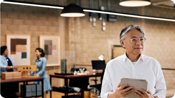 man standing holding papers