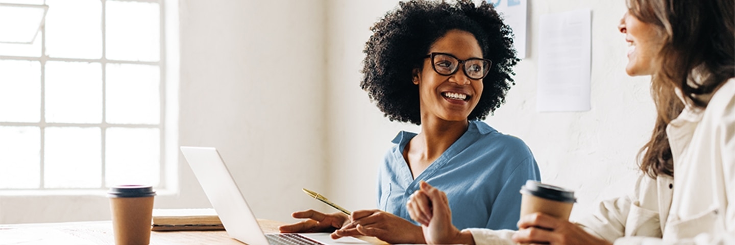 Woman wearing glasses is smiling and looking away