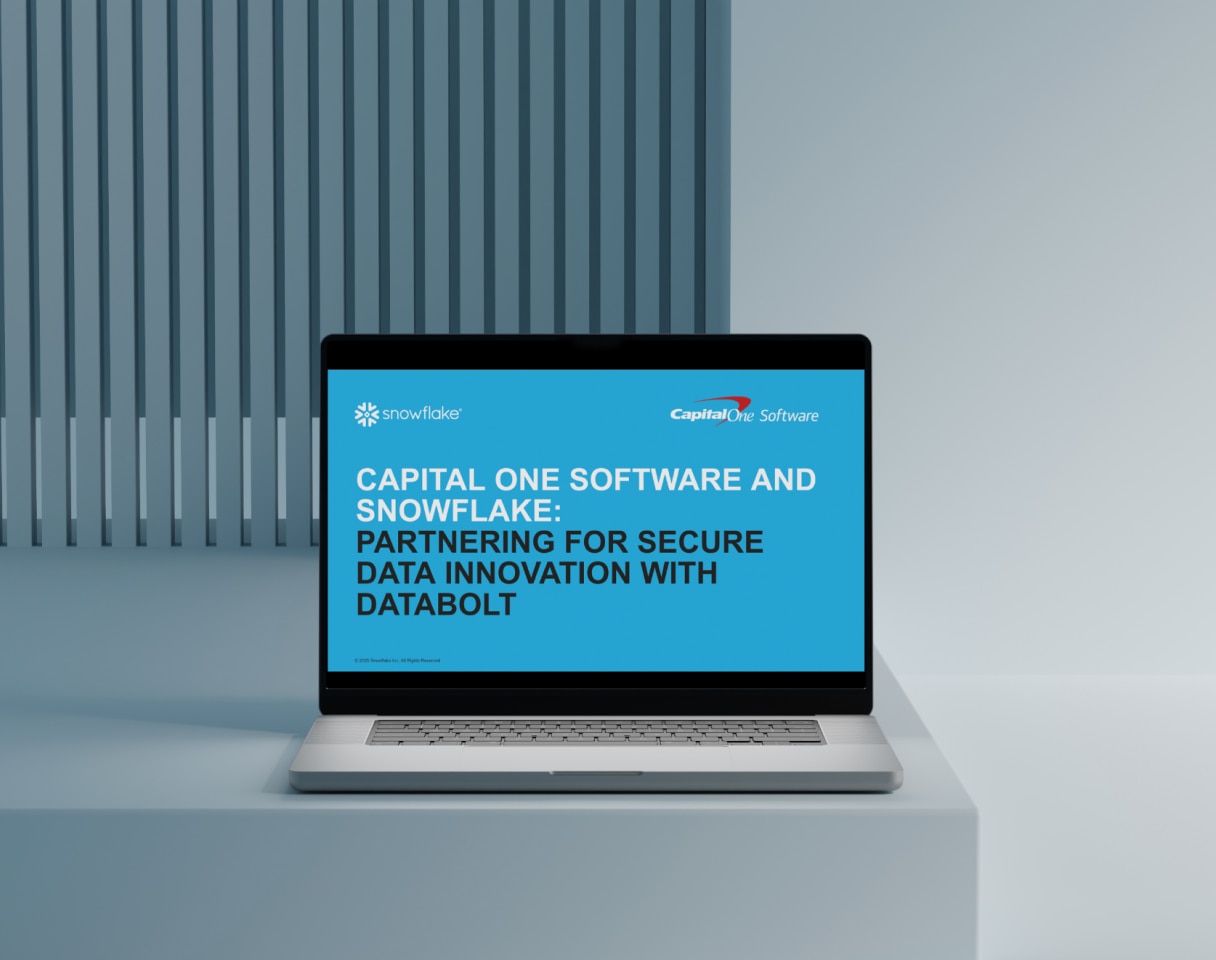 Open laptop displaying Capital One Software and Snowflake webinar title card