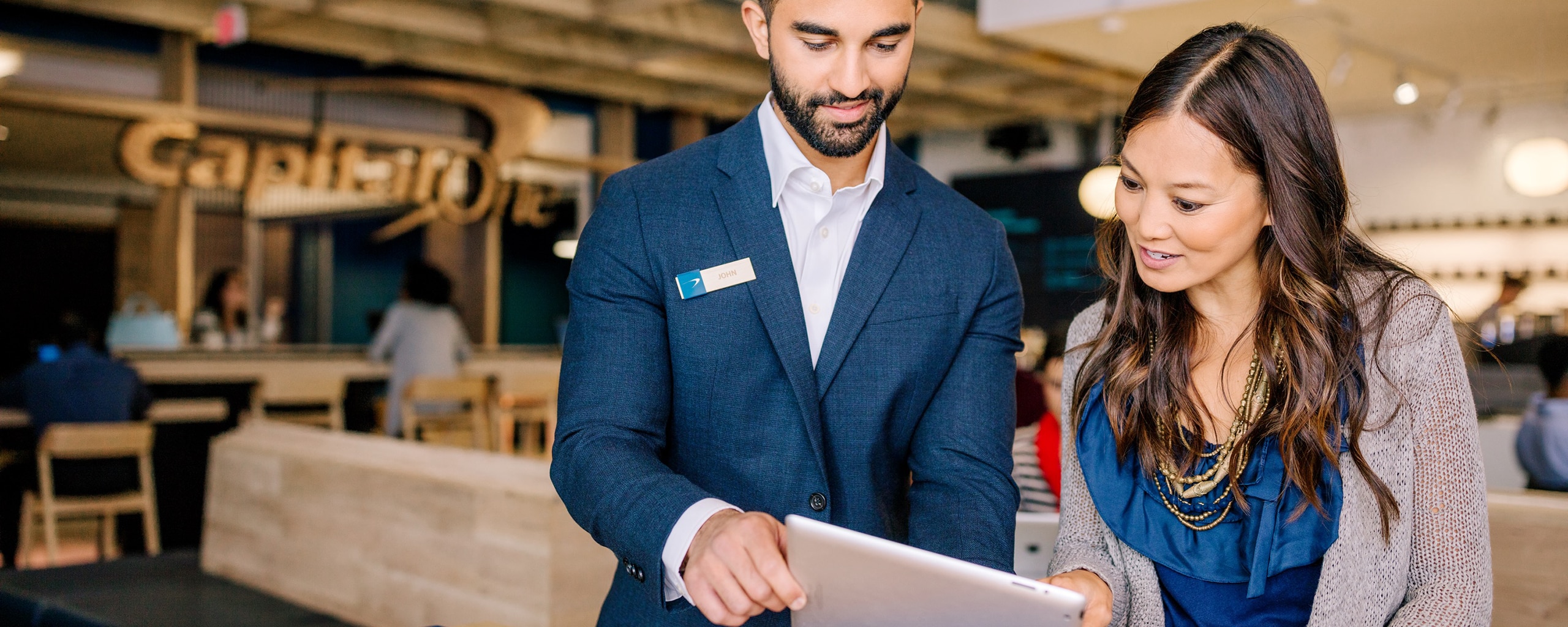 associate and customer talking at Capital One cafe