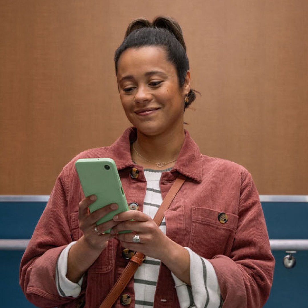 Woman smiling looking at her phone