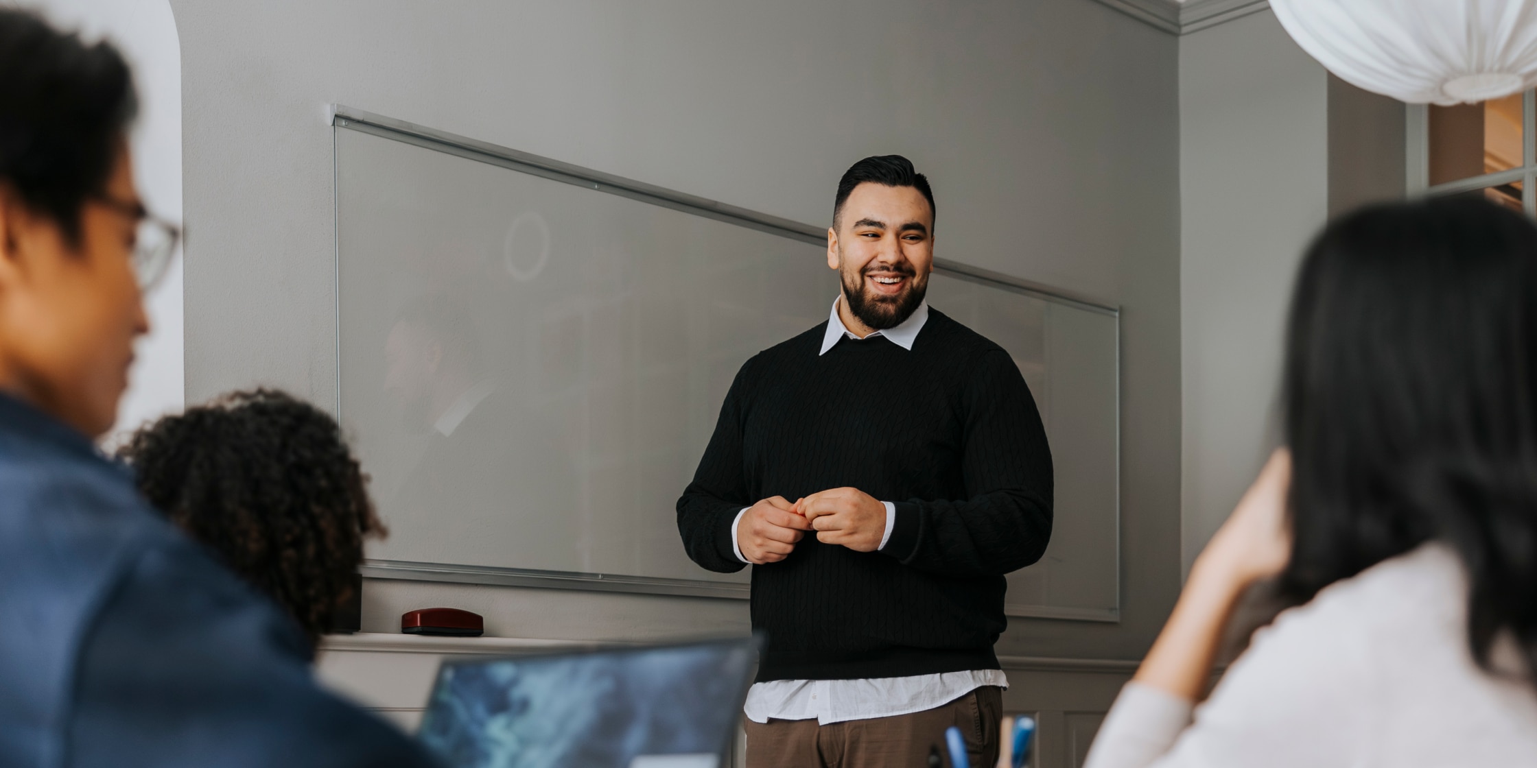 A professor in a classroom speaking to a room of students