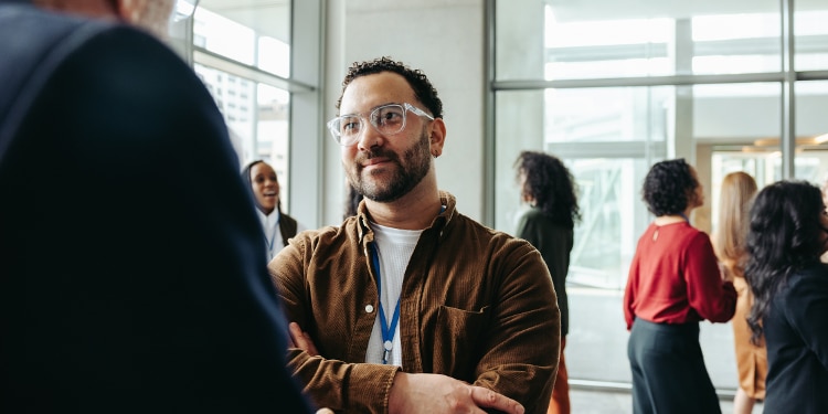Man listening to colleague at conference.