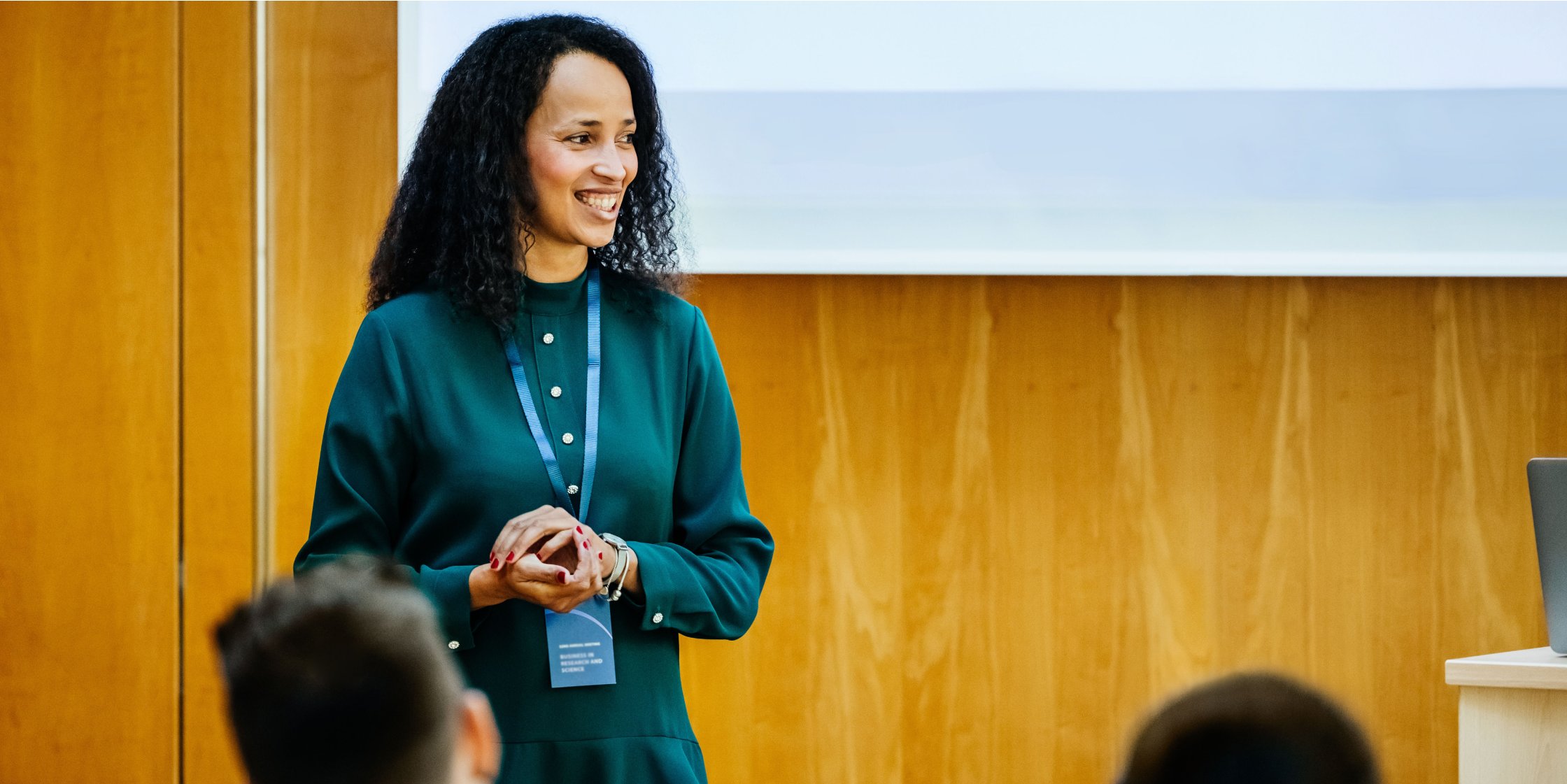 Woman in front of audience smiling