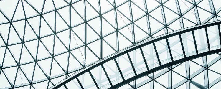 shot looking up at the triangular panes of a large glass ceiling