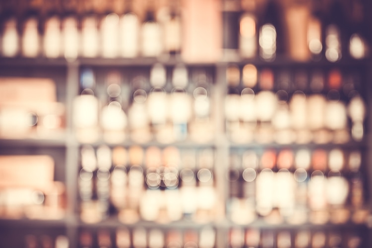 blurred bottles on bar shelves