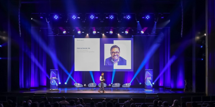 Prem Natarajan, PhD, presents session on stage at Capital One's inaugural AI Symposium