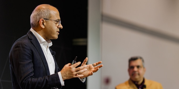 Man presenting at NVIDIA GTC 2026 as another man watches