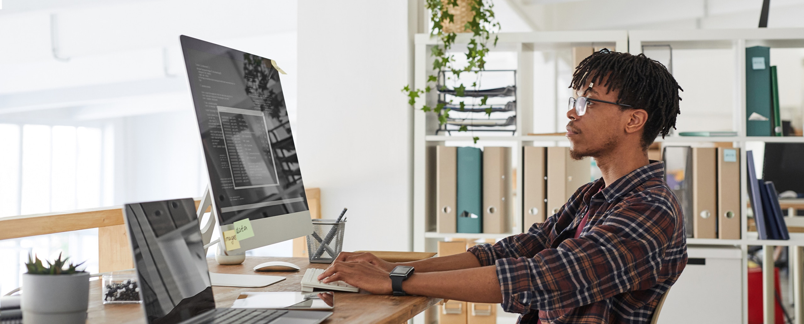 Tech associate working on code at computer